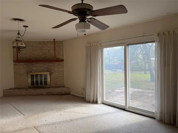 a view of a livingroom with a ceiling fan and window