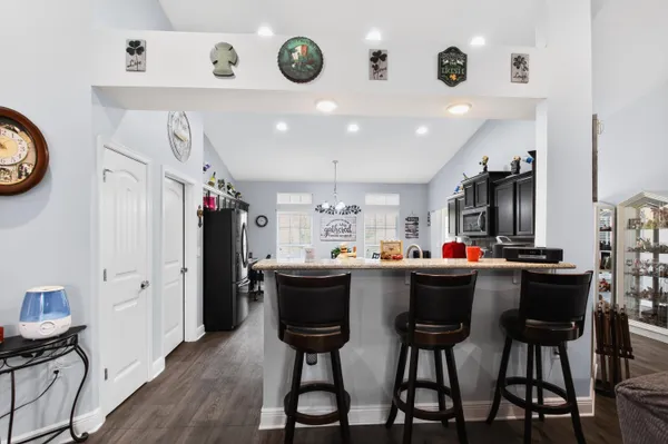 a kitchen with a dining table cabinets and stainless steel appliances
