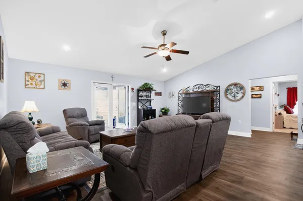 a living room with furniture and a wooden floor