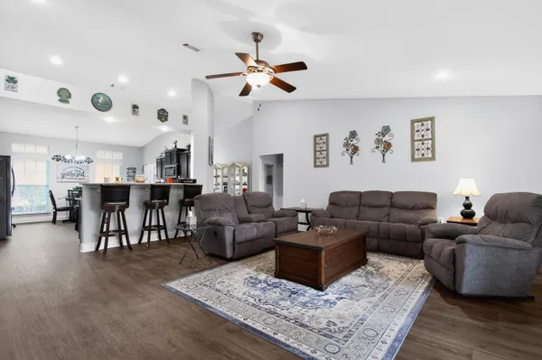 a living room with furniture and a dining table