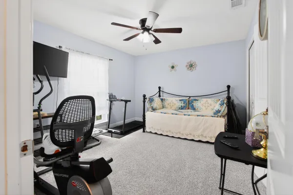 a bedroom with bed and a chandelier
