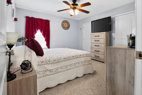 a bedroom with a bed and a flat screen tv