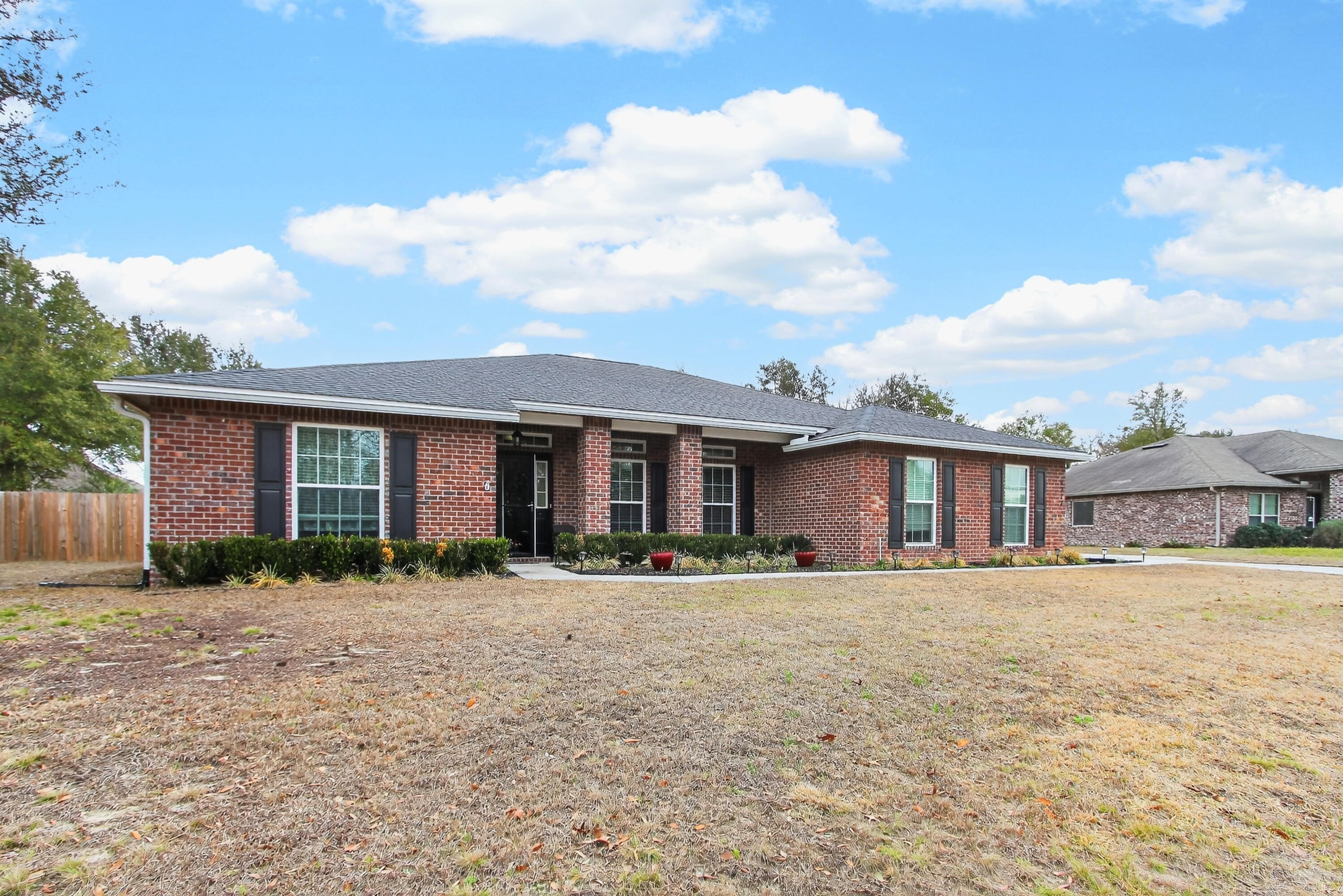 6317 Antigone Circle Crestview, FL 32536 - Photo 2 of 32 a front view of a house with a yard
