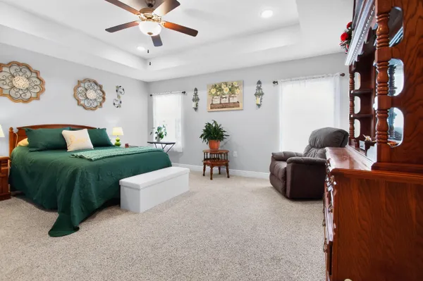 a bedroom with a bed a window and dresser