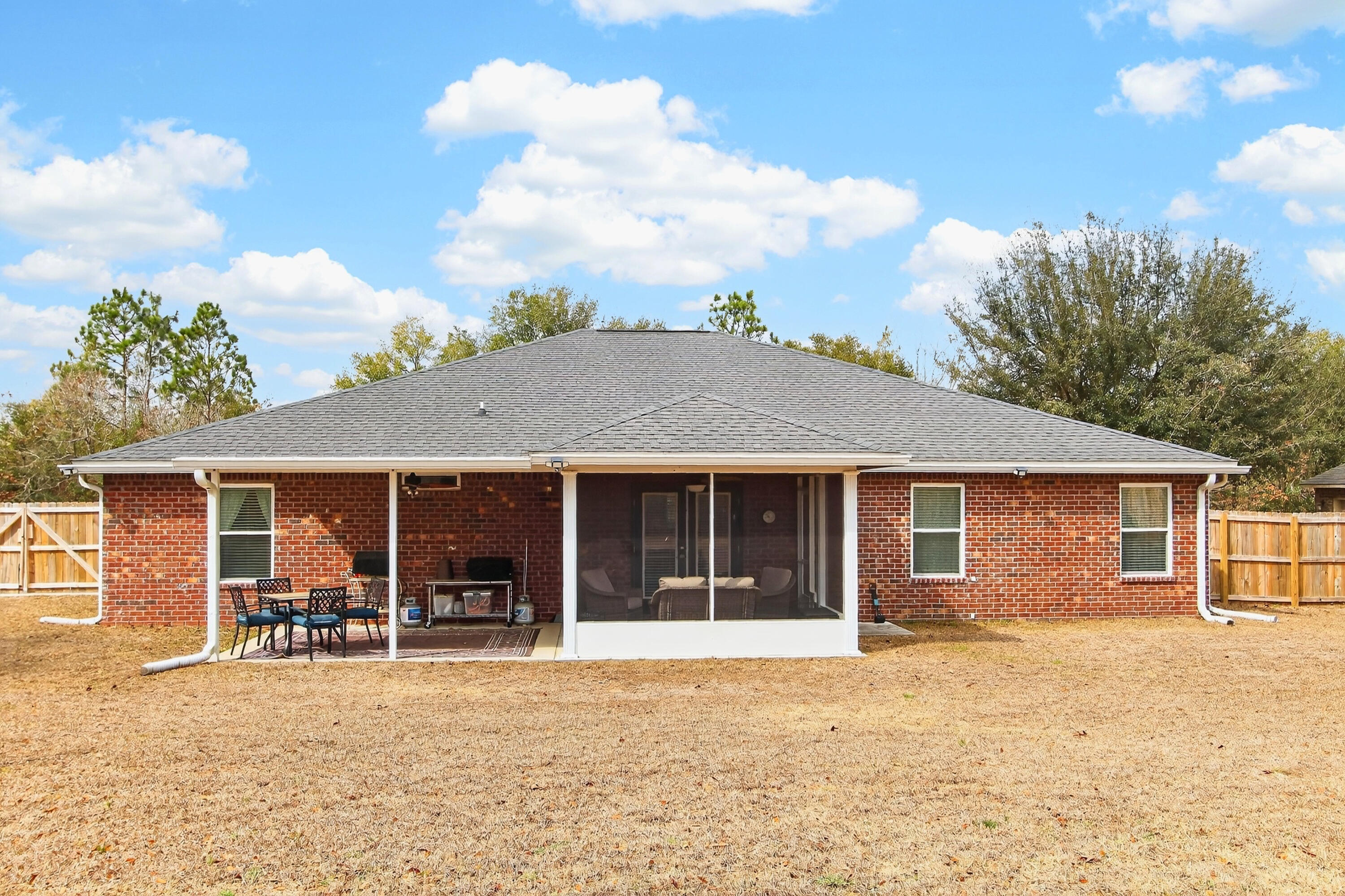 6317 Antigone Circle Crestview, FL 32536 - Photo 31 of 32 a view of a house with table and chairs in patio