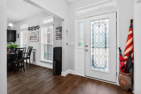 a view of an empty room with furniture and wooden floor