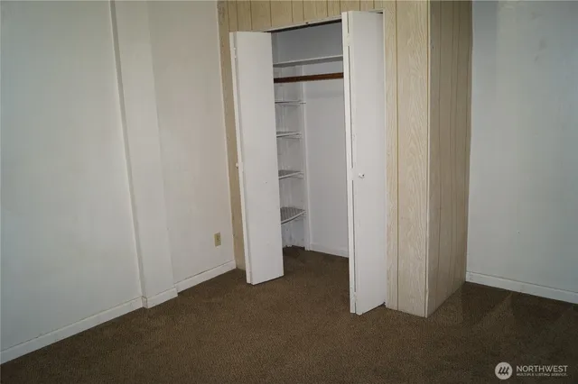 an empty room with closet area