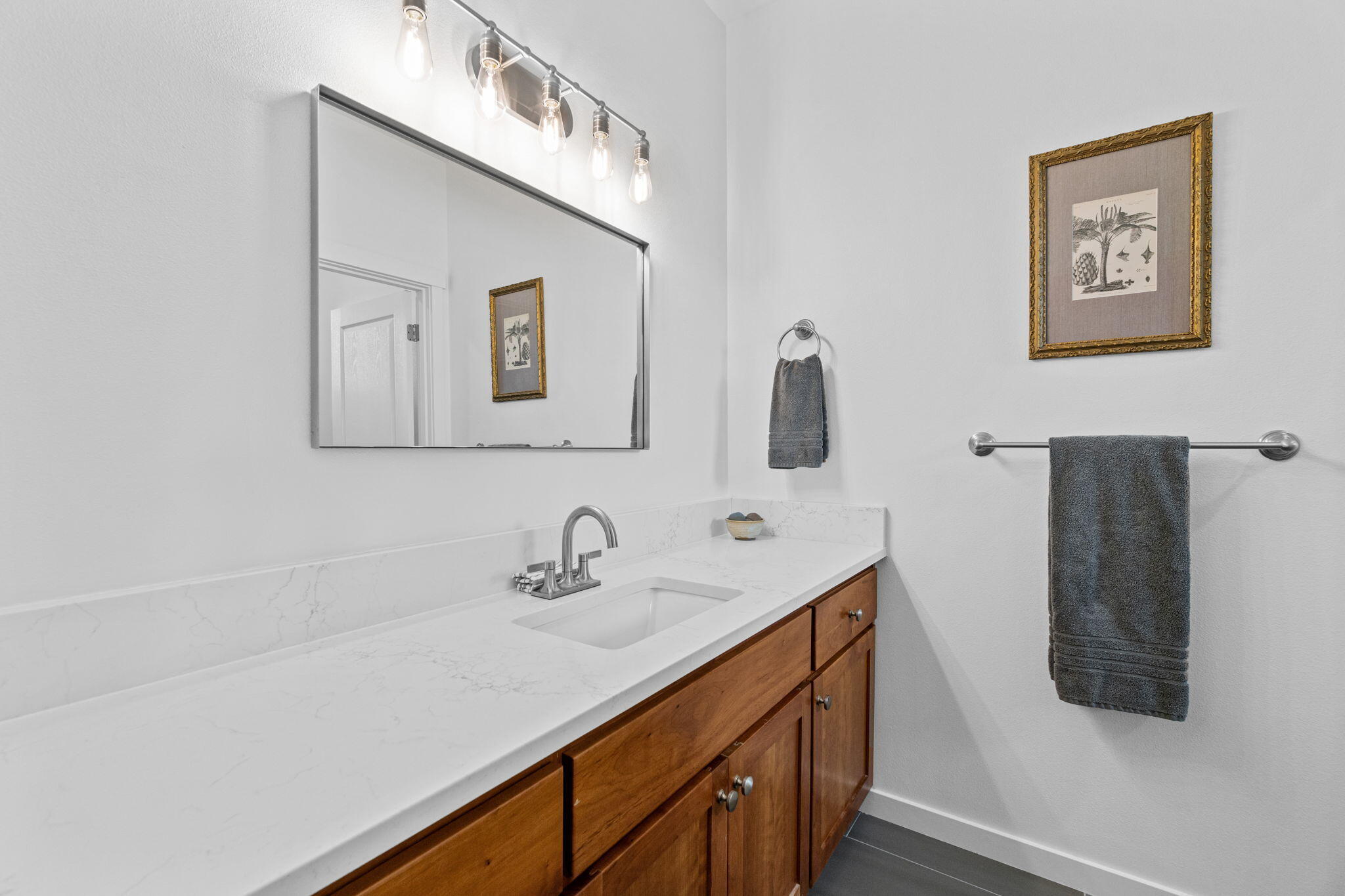 10942 Village Loop Redmond, OR 97756 - Photo 32 of 45 a bathroom with a sink and a mirror