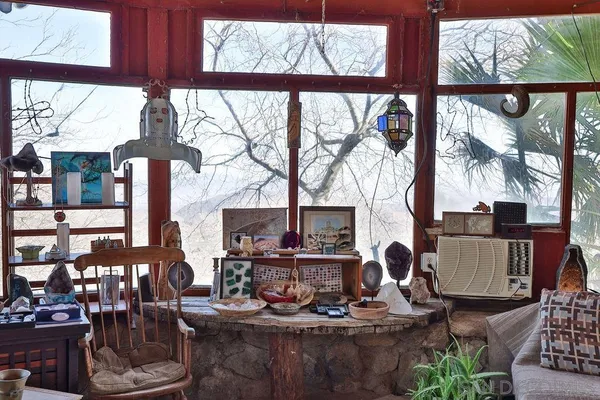 a living room with furniture and a floor to ceiling window