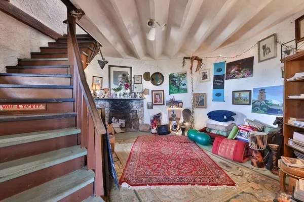 a living room with lots of furniture and a rug
