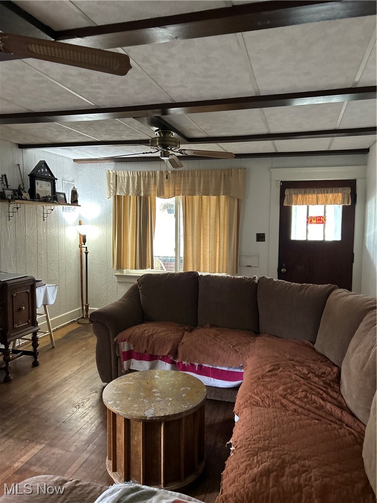 11406 Bellaire Road Cleveland, OH 44111 - Photo 3 of 28 Living room featuring hardwood / wood-style flooring, a ceiling fan, and wooden walls