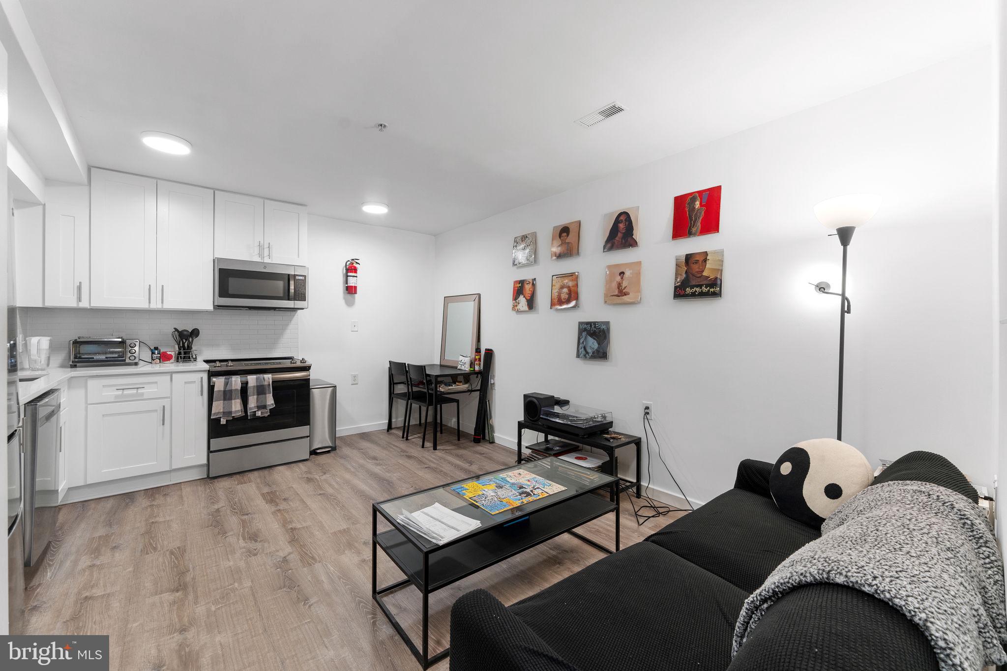 1119 6th Street Northwest, Unit 3 Washington, DC 20001 - Photo 2 of 9 a living room with furniture and a flat screen tv