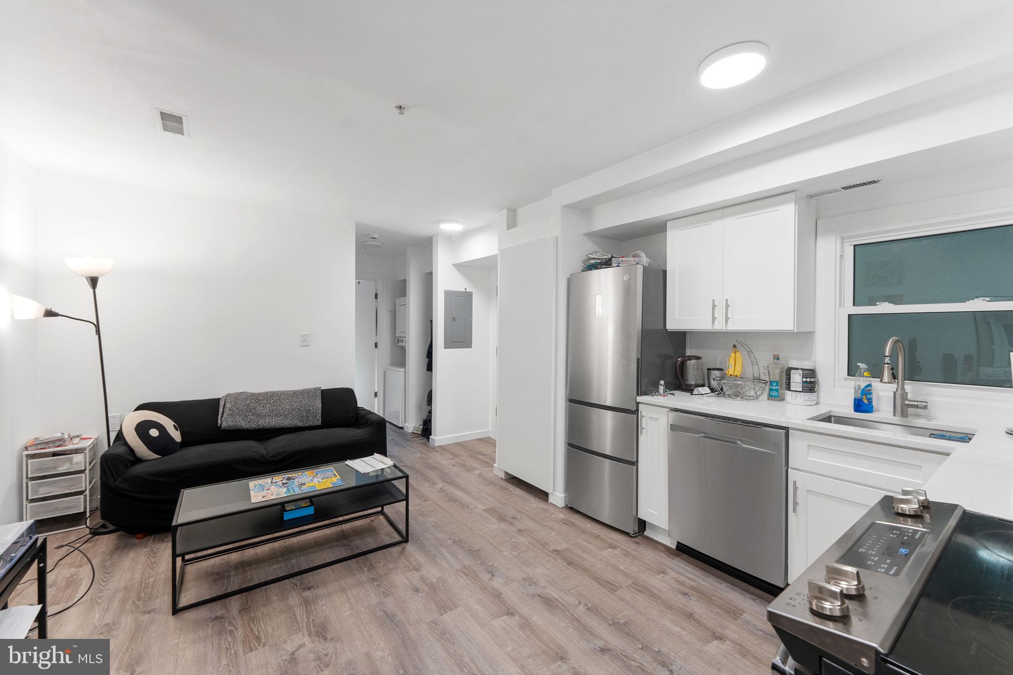 1119 6th Street Northwest, Unit 3 Washington, DC 20001 - Photo 3 of 9 a living room with furniture and a wooden floor