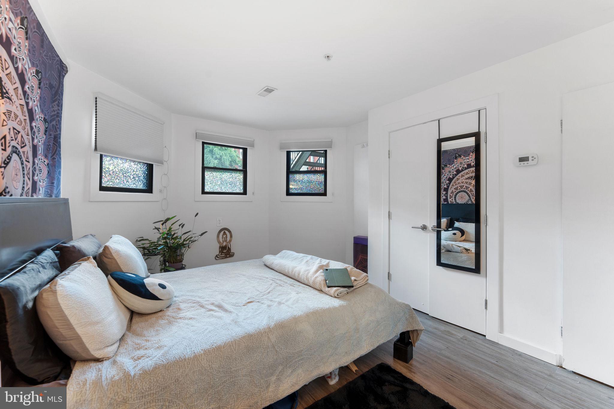 1119 6th Street Northwest, Unit 3 Washington, DC 20001 - Photo 6 of 9 a bedroom with a bed and a chair