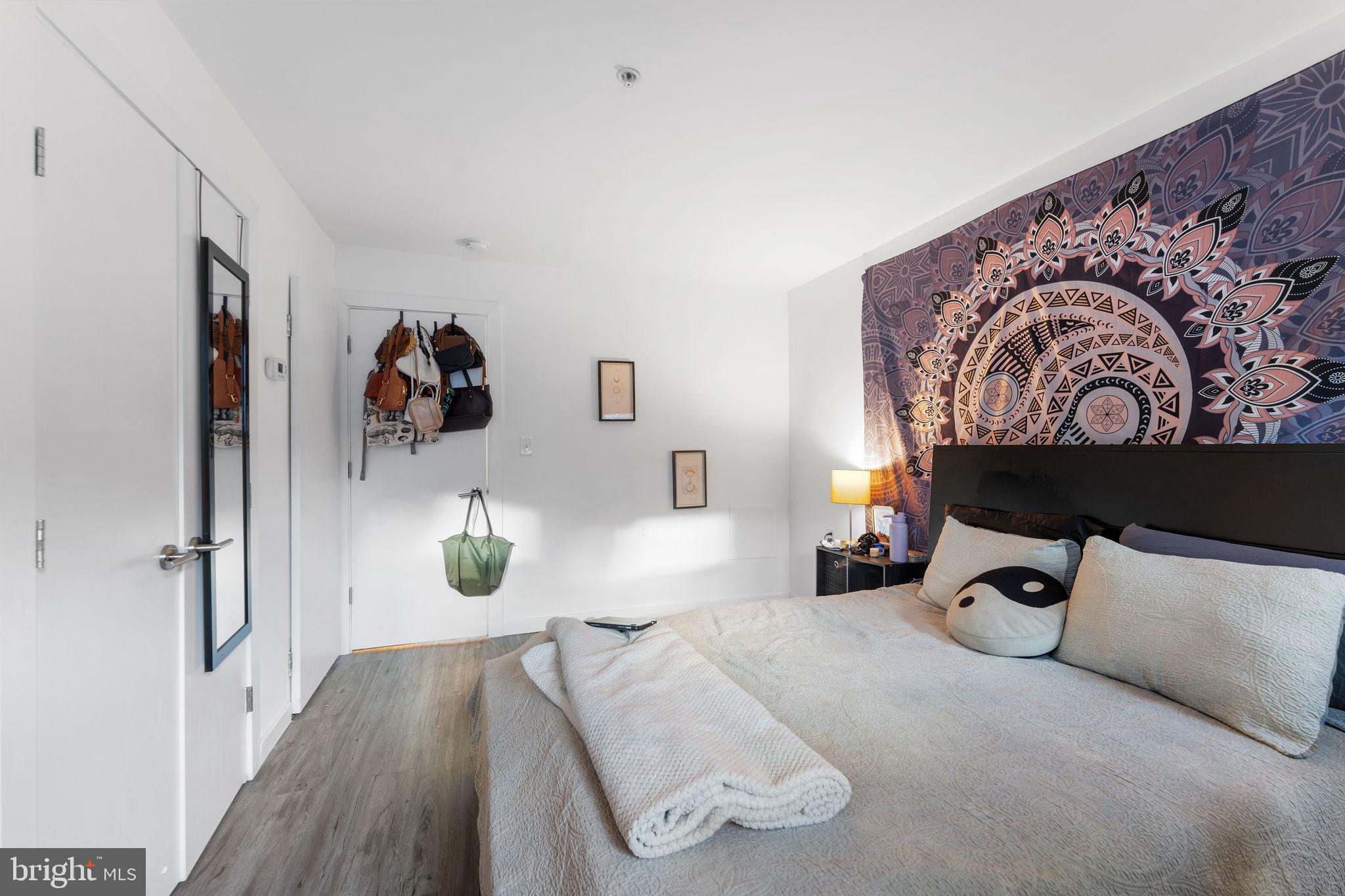 1119 6th Street Northwest, Unit 3 Washington, DC 20001 - Photo 7 of 9 a bedroom with a bed and wooden floor