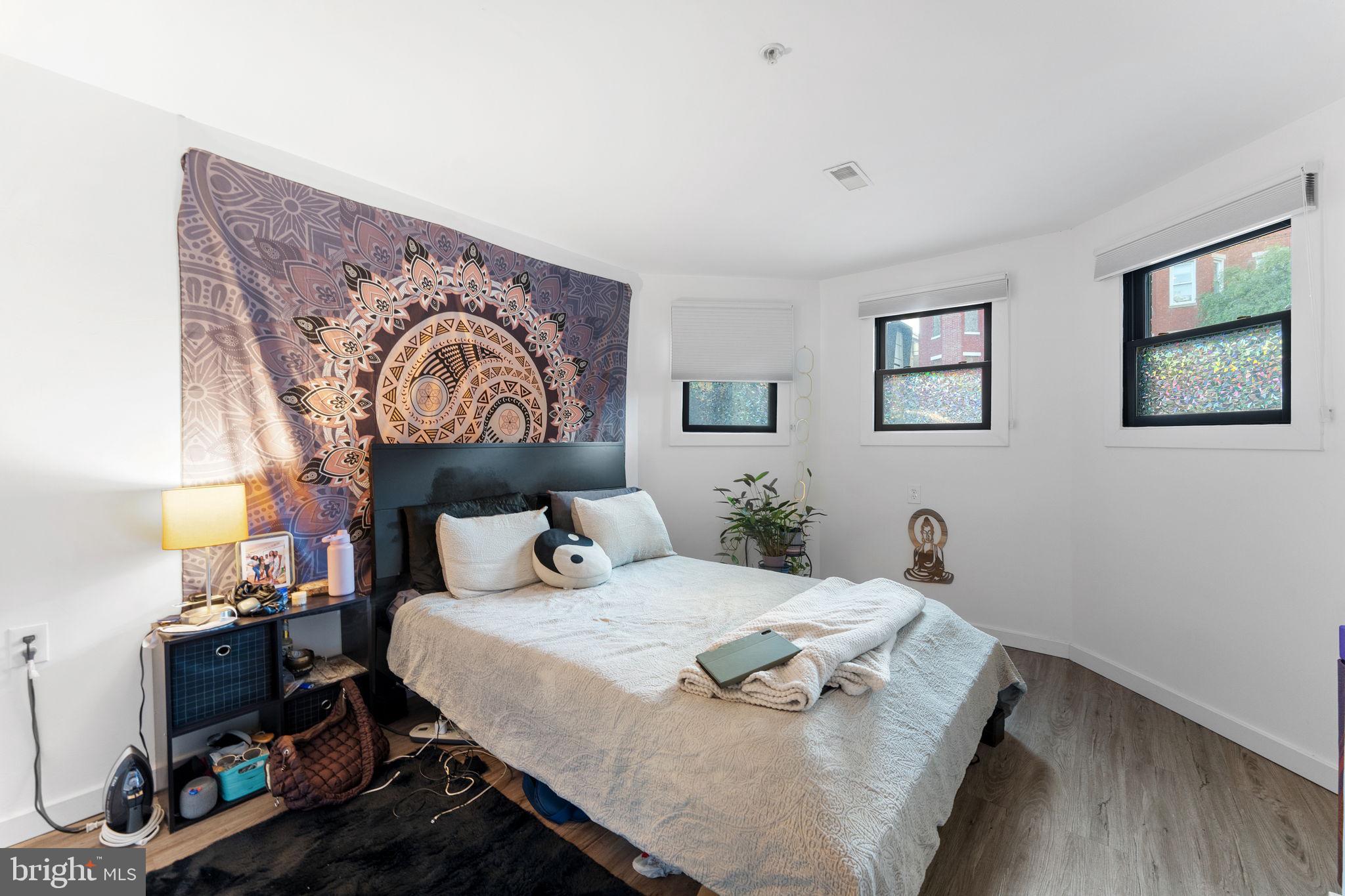 1119 6th Street Northwest, Unit 3 Washington, DC 20001 - Photo 8 of 9 a bedroom with a bed and wooden floor