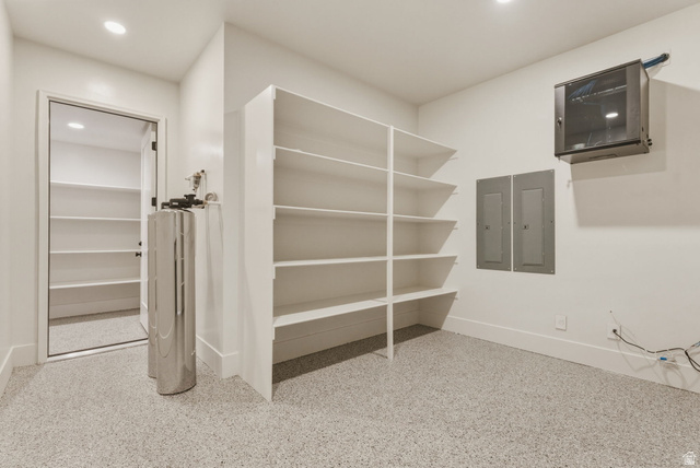 923 North Emery Lane Elk Ridge, UT 84651 - Photo 68 of 101 Utility room featuring epoxy flooring, built-in shelving, recessed lighting, and a water filtration system