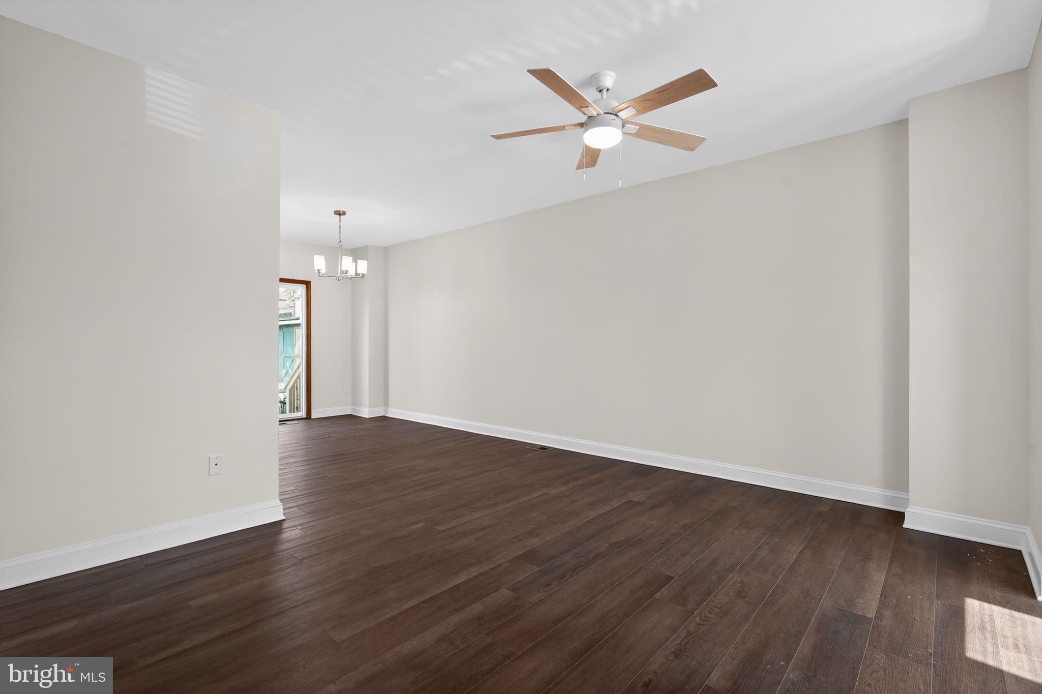 511 3rd Avenue Audubon, NJ 08106 - Photo 4 of 23 an empty room with wooden floor fan and windows