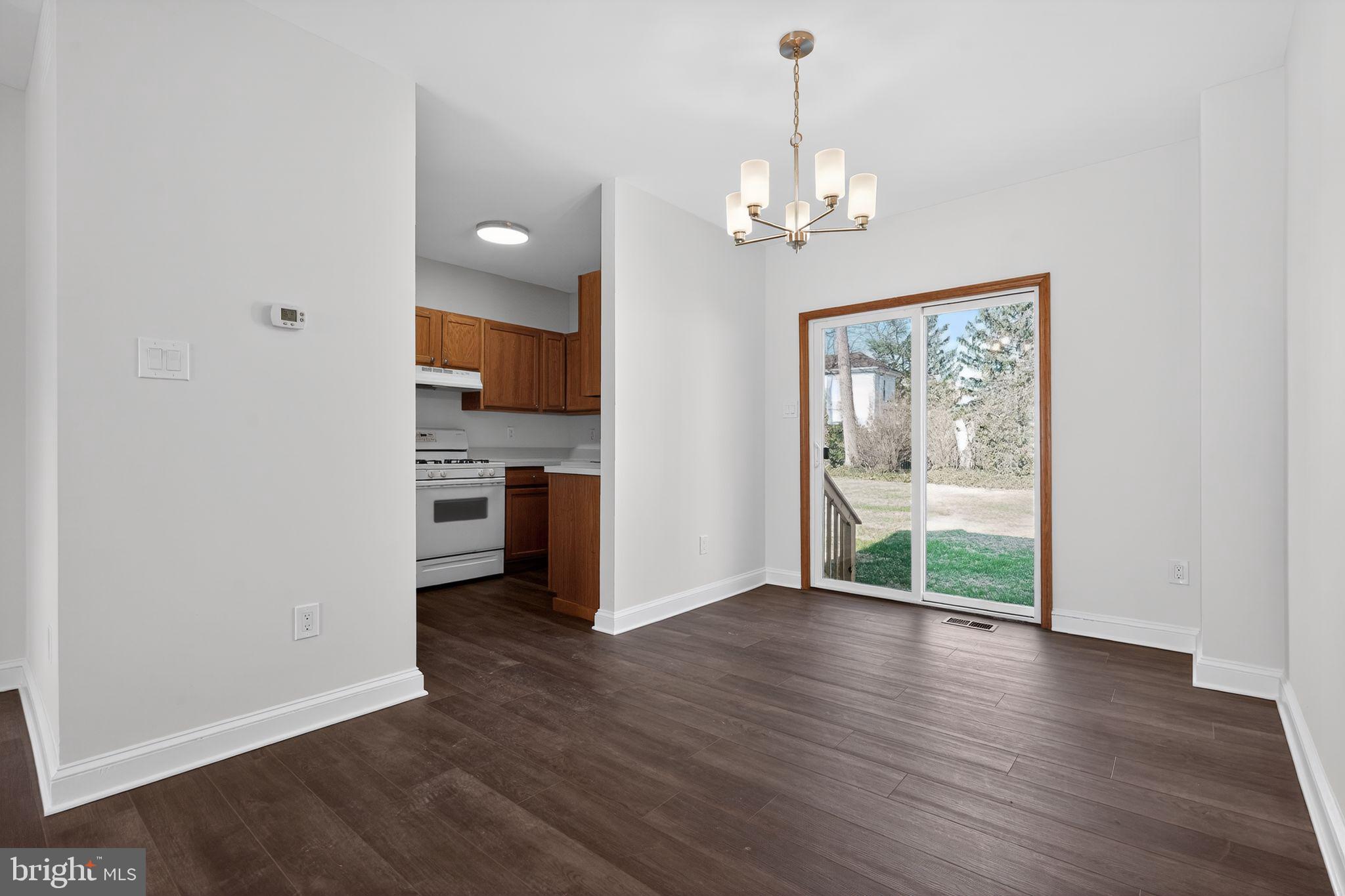 511 3rd Avenue Audubon, NJ 08106 - Photo 6 of 23 a view of a hallway with wooden floor and a kitchen