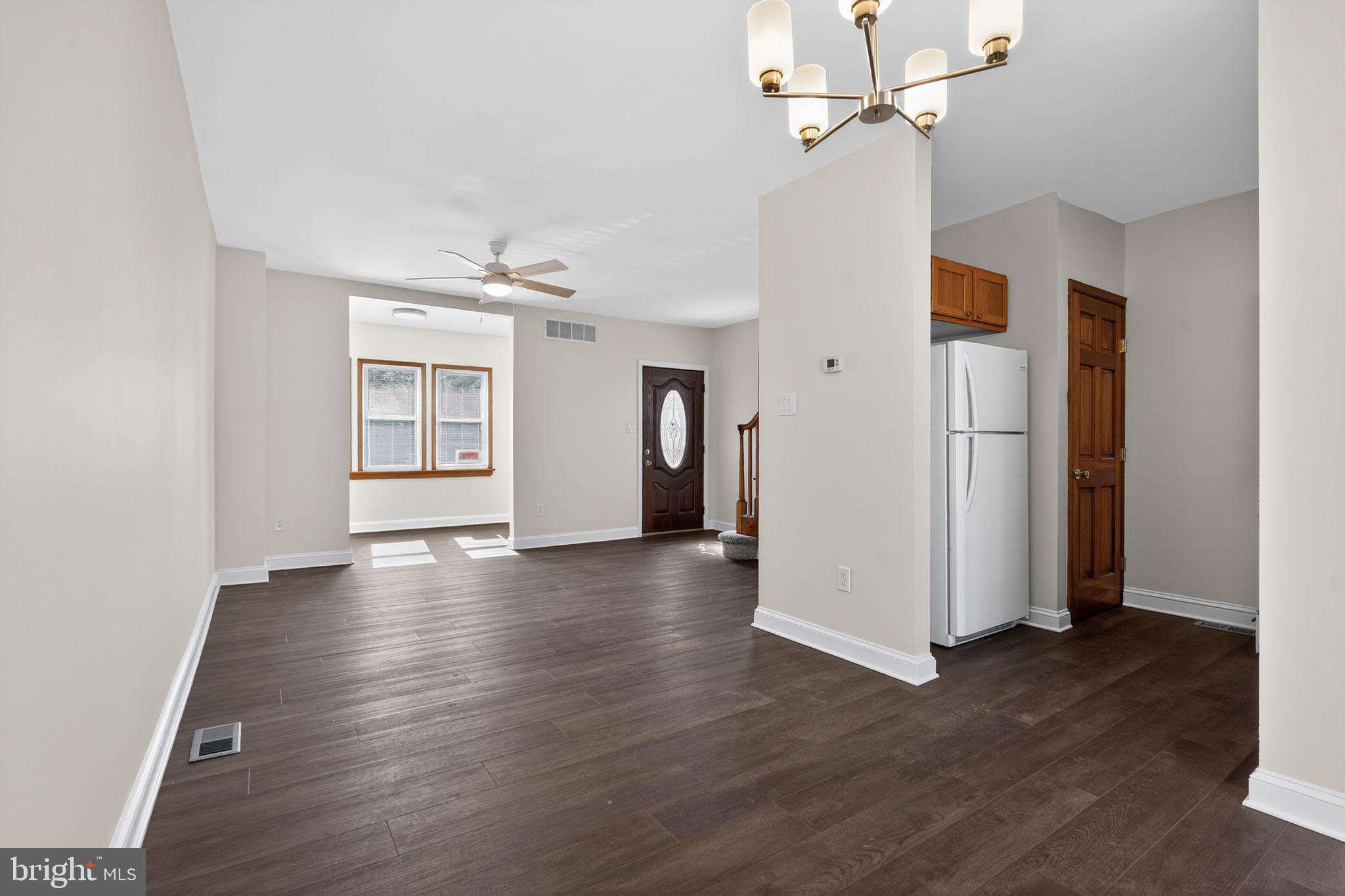 511 3rd Avenue Audubon, NJ 08106 - Photo 9 of 23 an empty room with wooden floor ceiling fan and windows