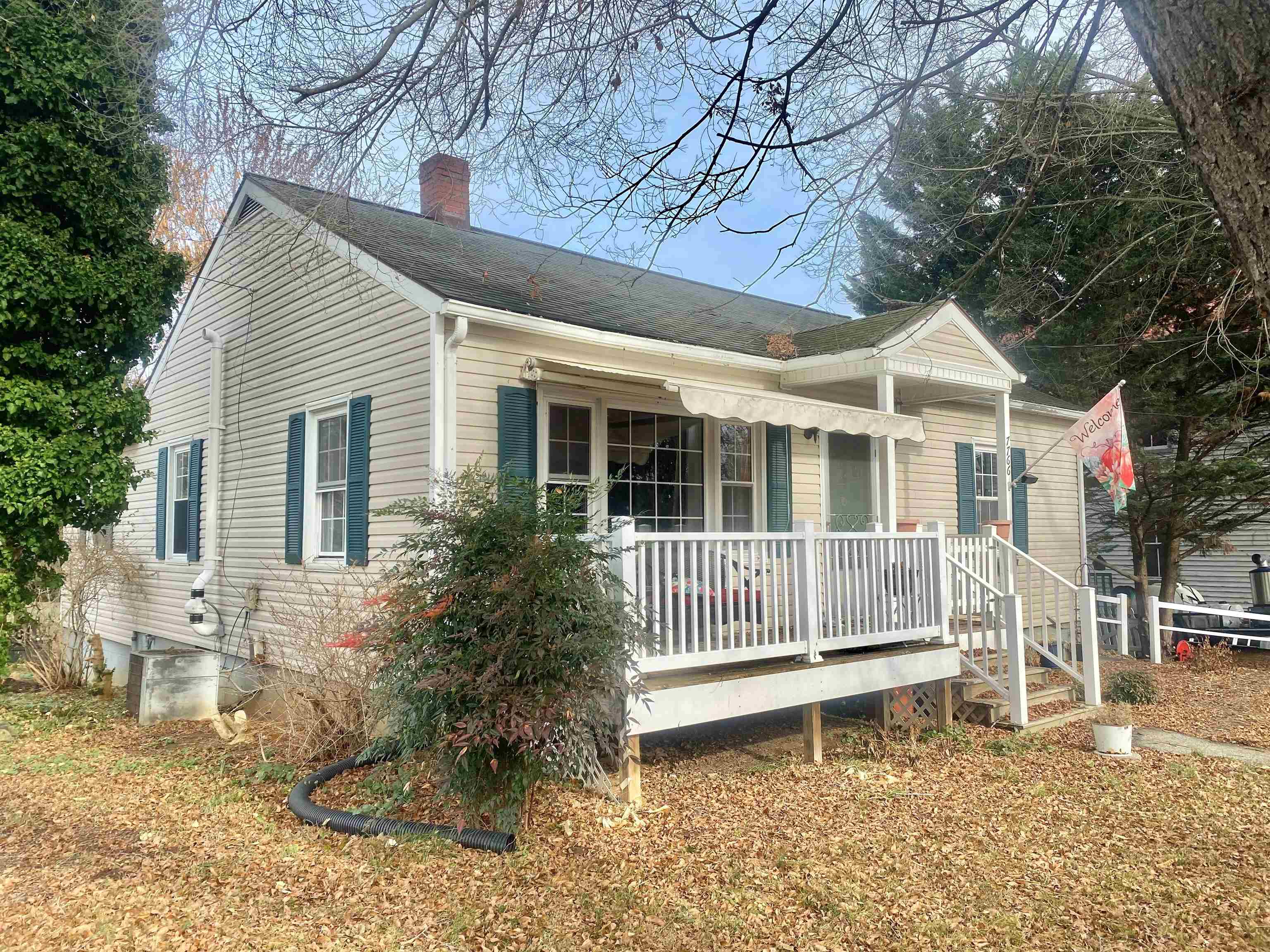 7766 Thomas Spring Road Bridgewater, VA 22812 - Photo 1 of 24 a wooden bench sitting in front of a house