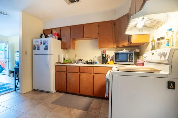 a kitchen with a refrigerator and a stove