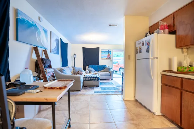 a kitchen with stainless steel appliances granite countertop a refrigerator and a sink