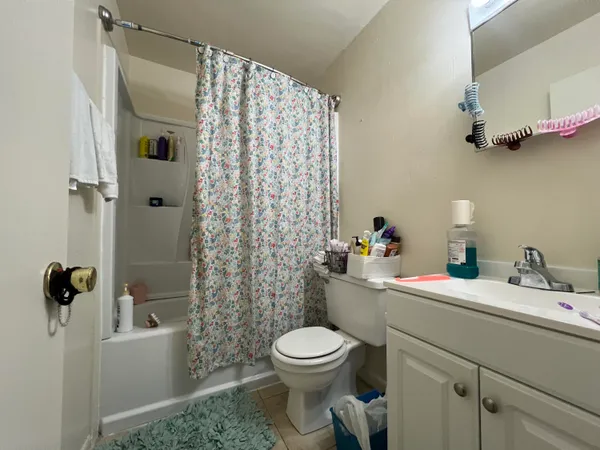 a bathroom with a shower and a bath tub