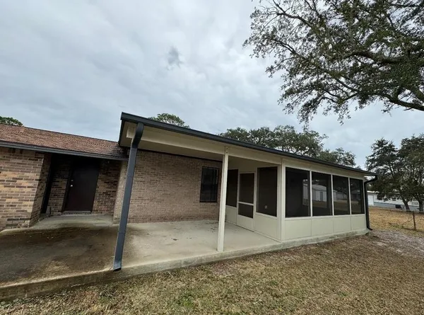 a view of a backyard with sitting area