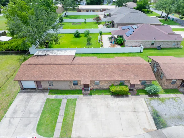 a aerial view of a house with a yard and a large pool