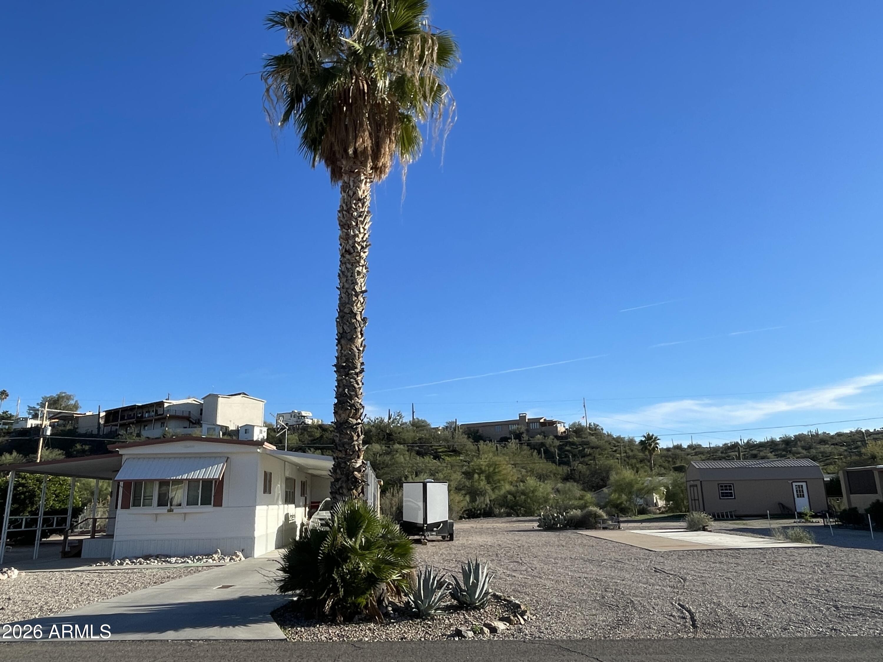 75 East Lynn Way Queen Valley, AZ 85118 - Photo 1 of 24 a view of a house with a yard and potted plants