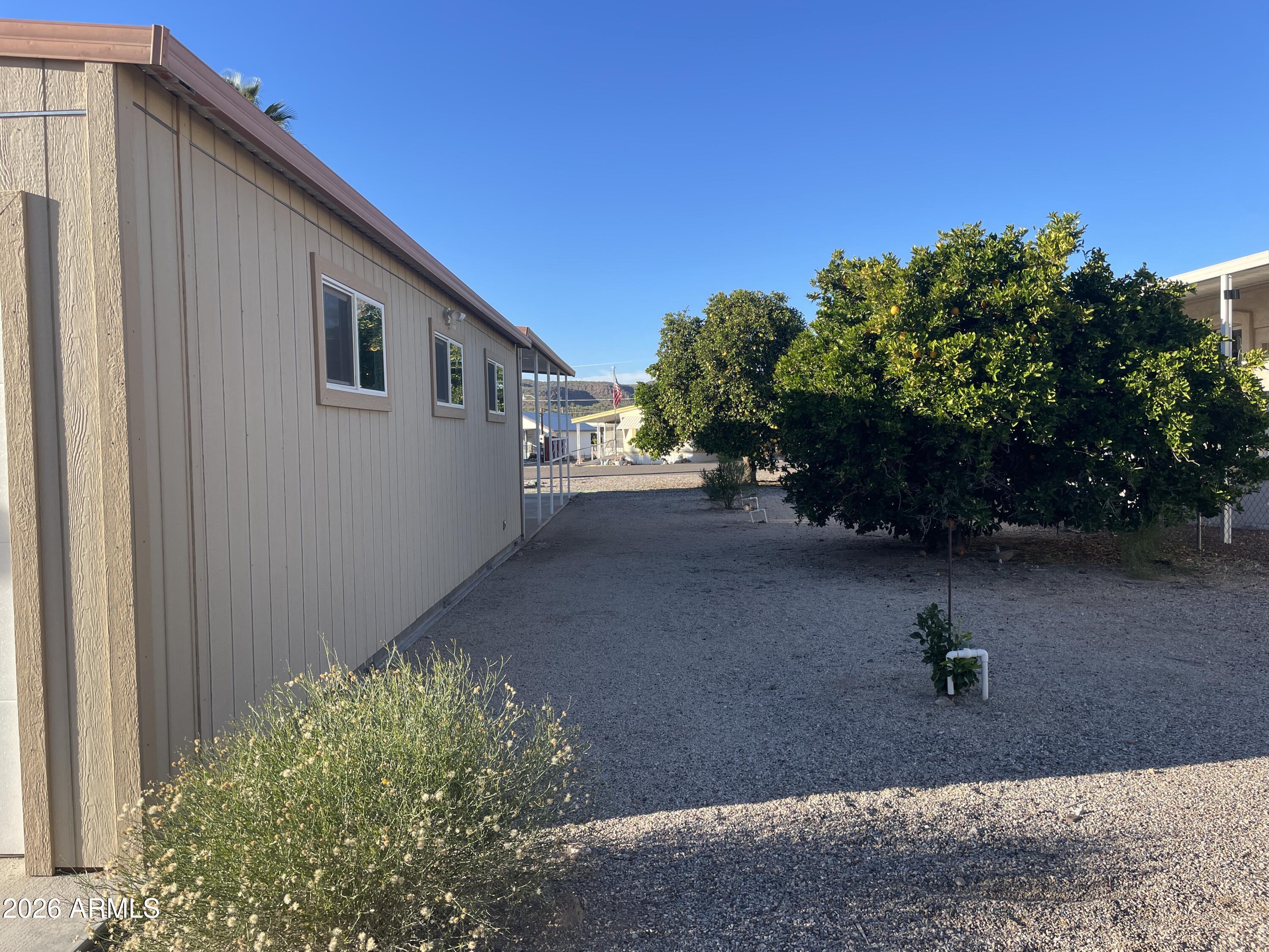 75 East Lynn Way Queen Valley, AZ 85118 - Photo 19 of 24 a front view of a house with a yard