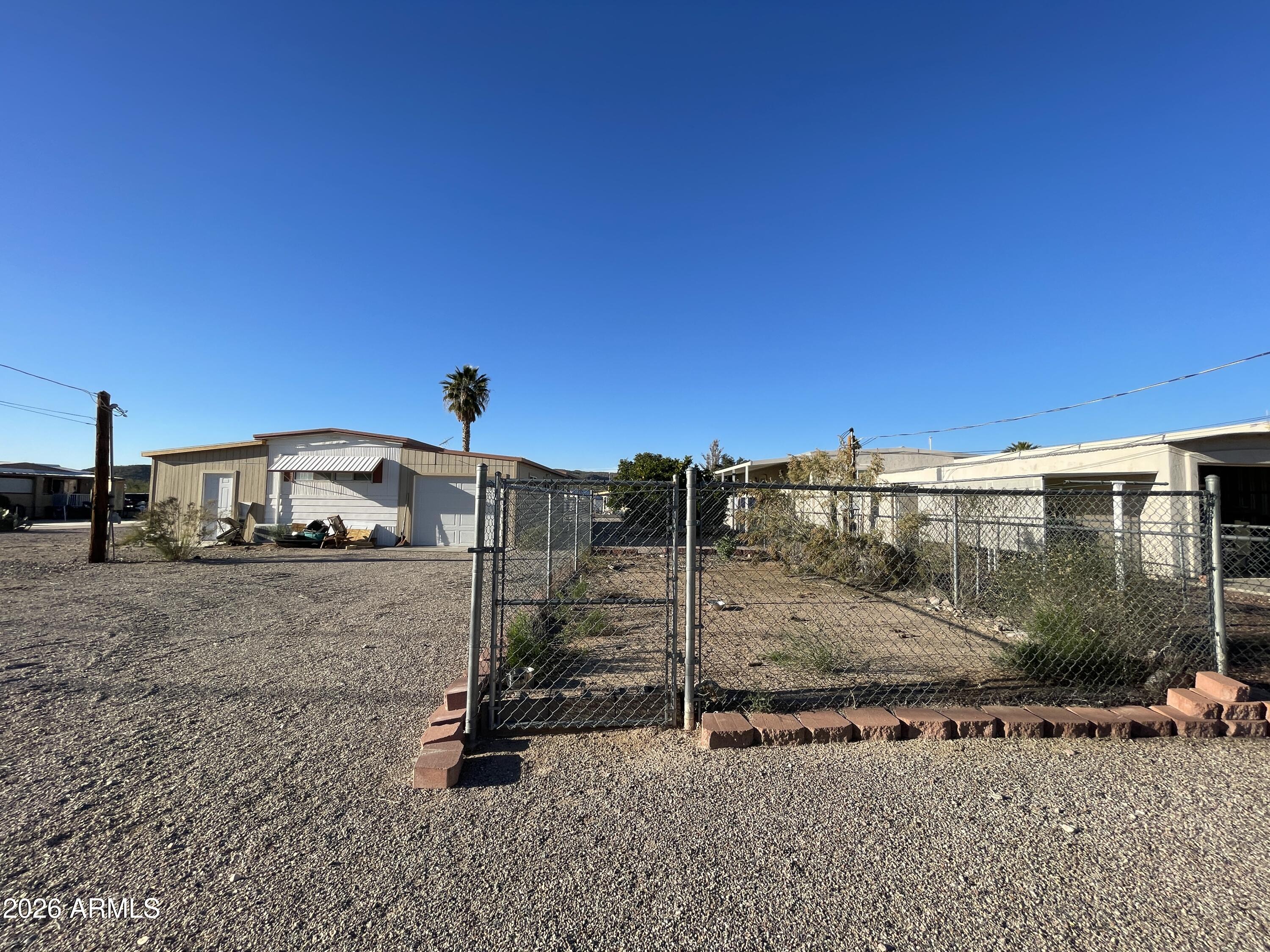 75 East Lynn Way Queen Valley, AZ 85118 - Photo 20 of 24 a view of a street with a building in the background