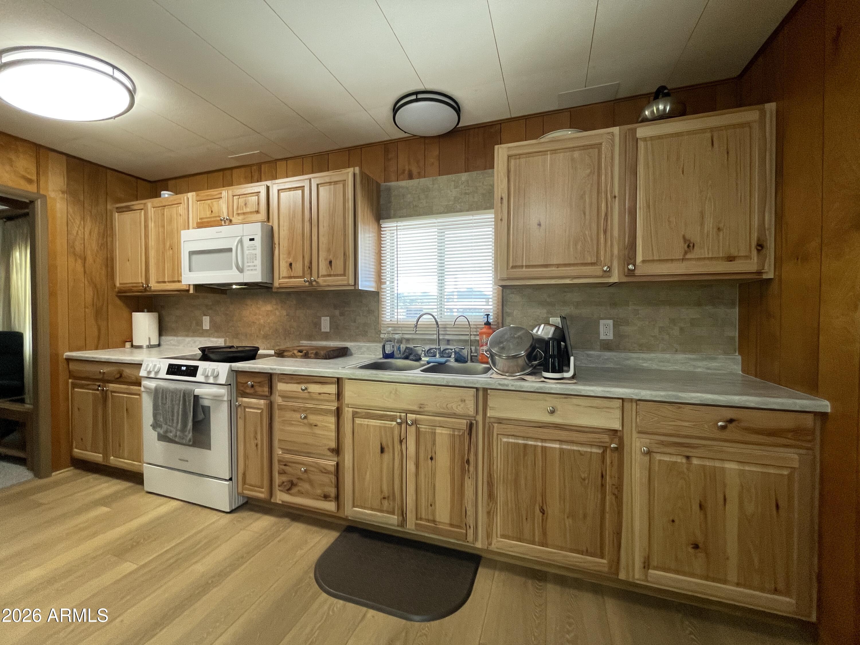 75 East Lynn Way Queen Valley, AZ 85118 - Photo 9 of 24 a kitchen with a sink cabinets and window