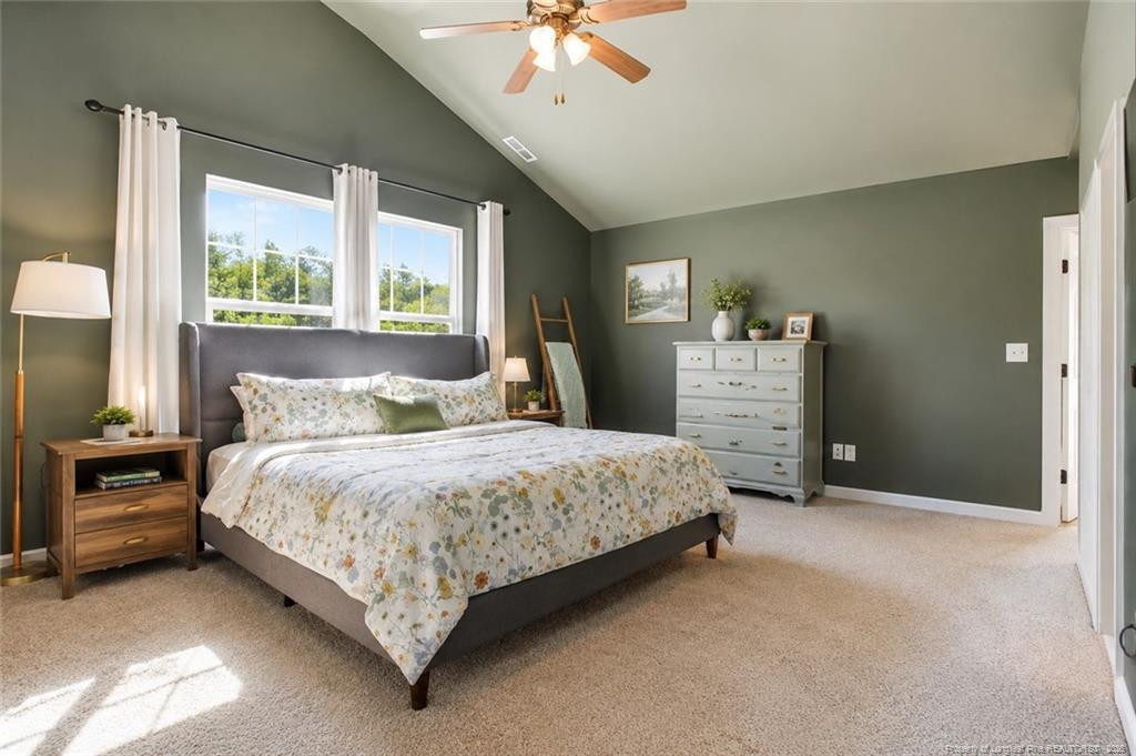 334 Crane Way Bunnlevel, NC 28323 - Photo 27 of 45 a bedroom with a bed and a chandelier