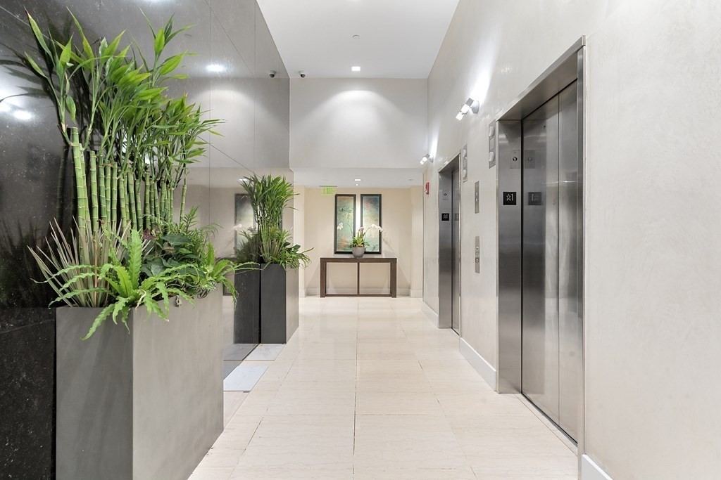 80 Broad Street, Unit 1002 Boston, MA 02110 - Photo 12 of 16 a view of a hallway with potted plant