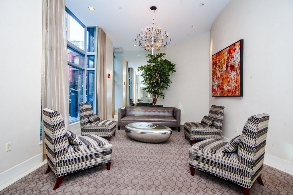 80 Broad Street, Unit 1002 Boston, MA 02110 - Photo 13 of 16 a living room with furniture flowerpot and a chandelier