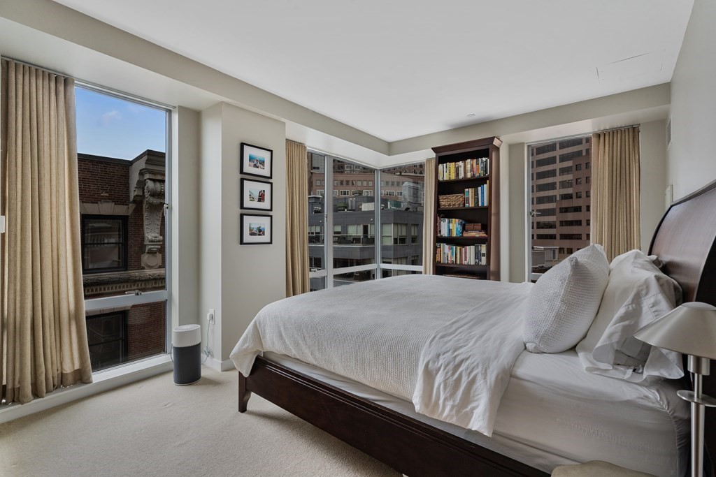 80 Broad Street, Unit 1002 Boston, MA 02110 - Photo 6 of 16 a bedroom with a large bed and a window
