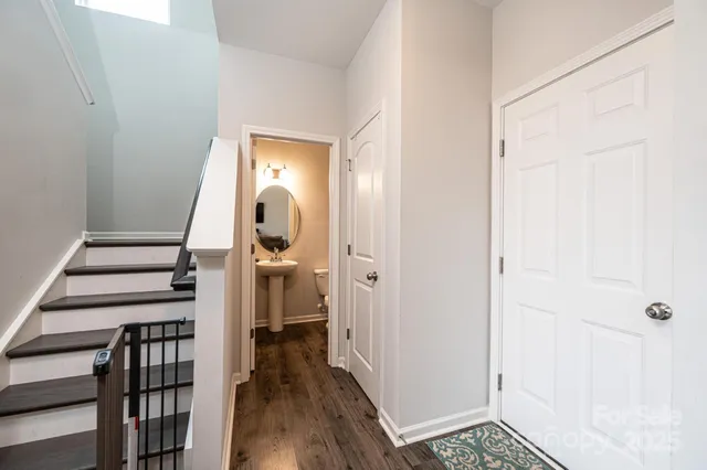 a view of a hallway with wooden floor and entryway