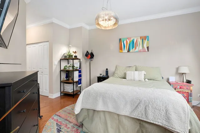 a bedroom with a bed and a chandelier