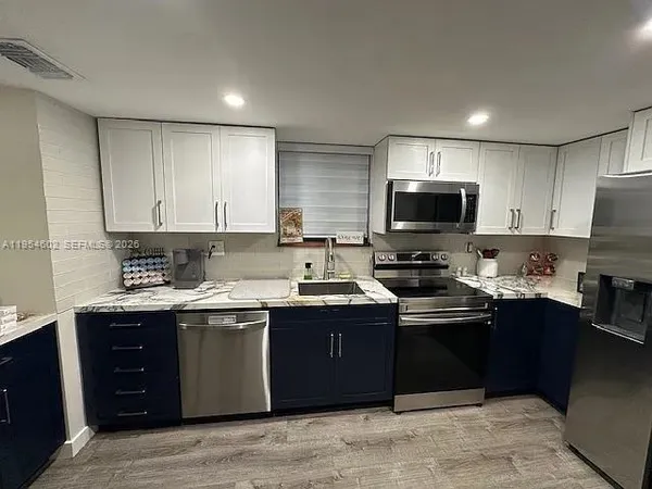 a kitchen with a sink stove and cabinets