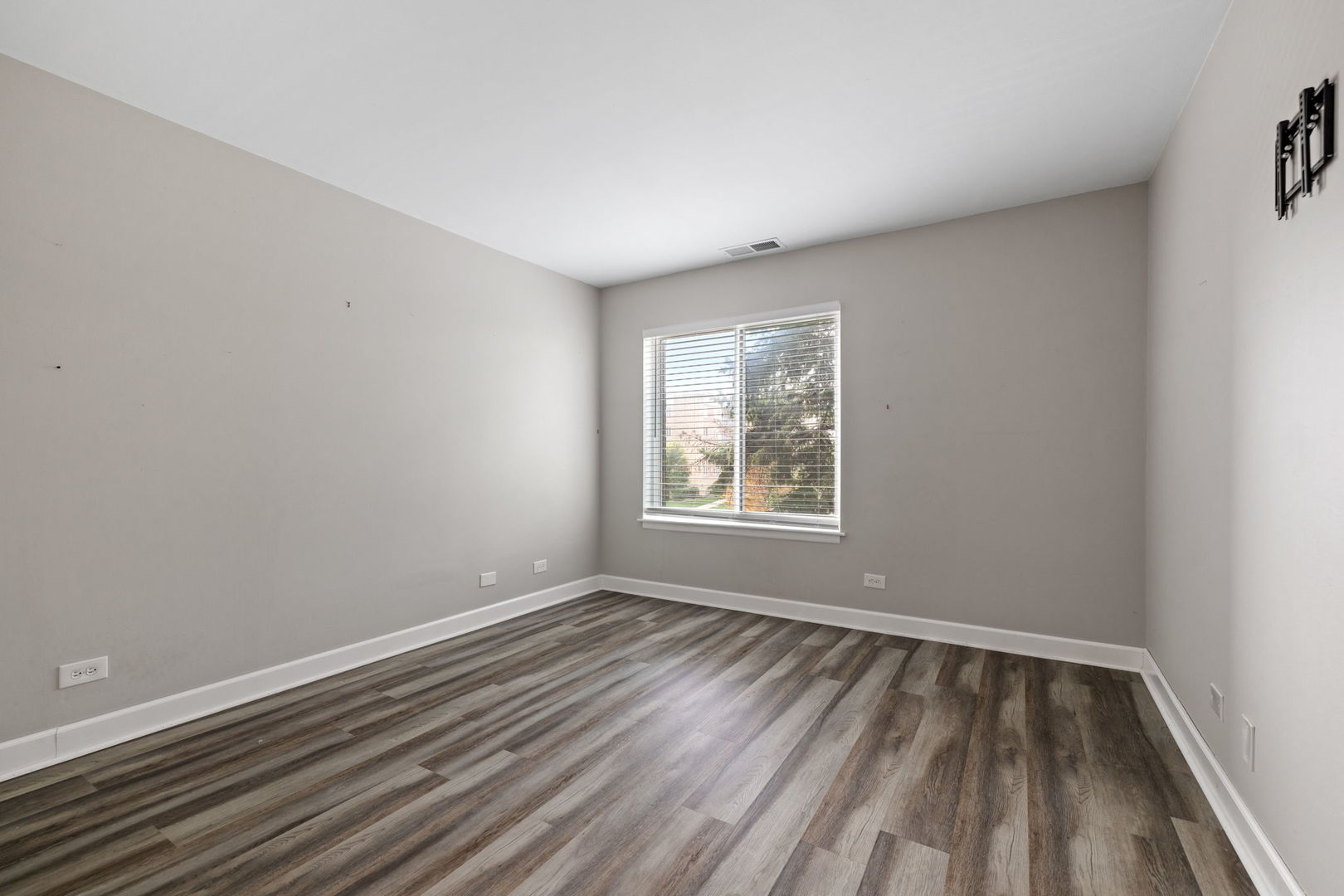 2201 South Grace Street, Unit 305 Lombard, IL 60148 - Photo 19 of 31 a view of an empty room with wooden floor and a window