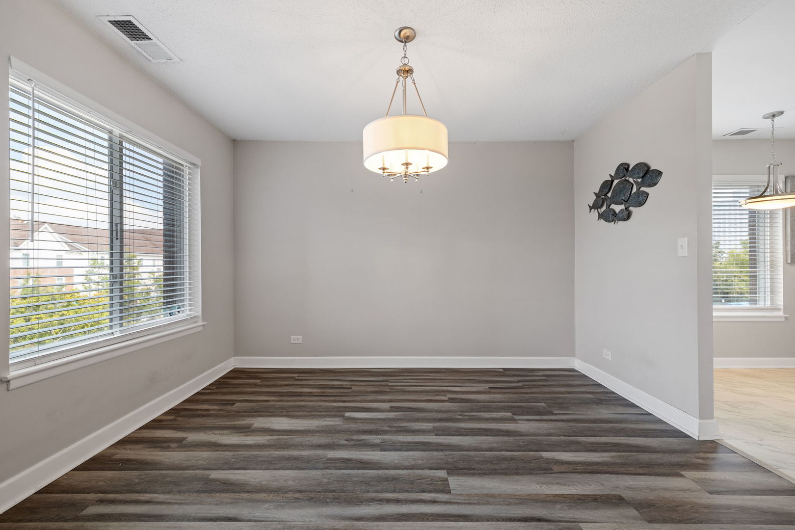 2201 South Grace Street, Unit 305 Lombard, IL 60148 - Photo 9 of 31 an empty room with wooden floor and windows