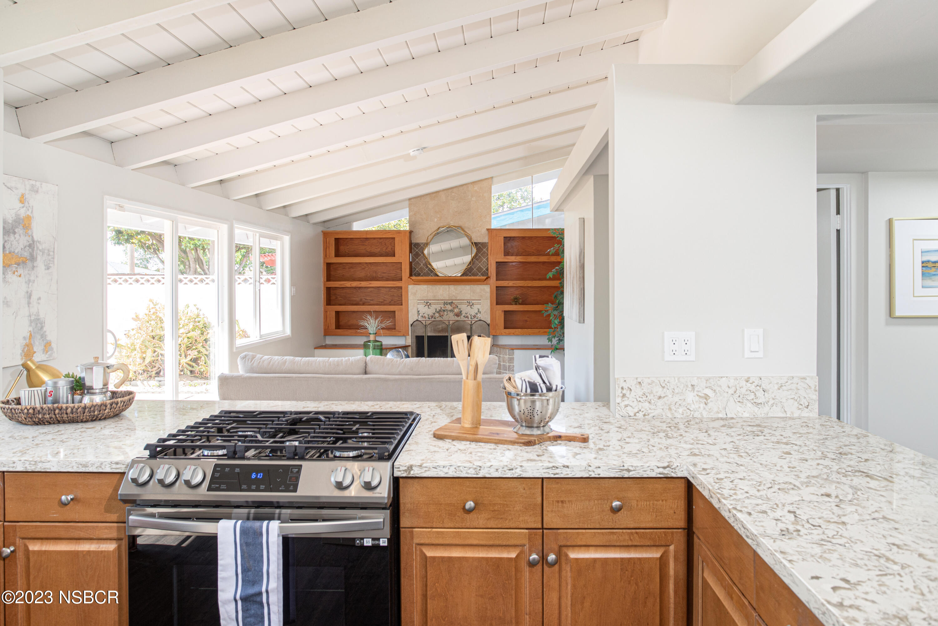 303 North Third Street Lompoc, CA 93436 - Photo 12 of 31 a kitchen with granite countertop a stove and a sink
