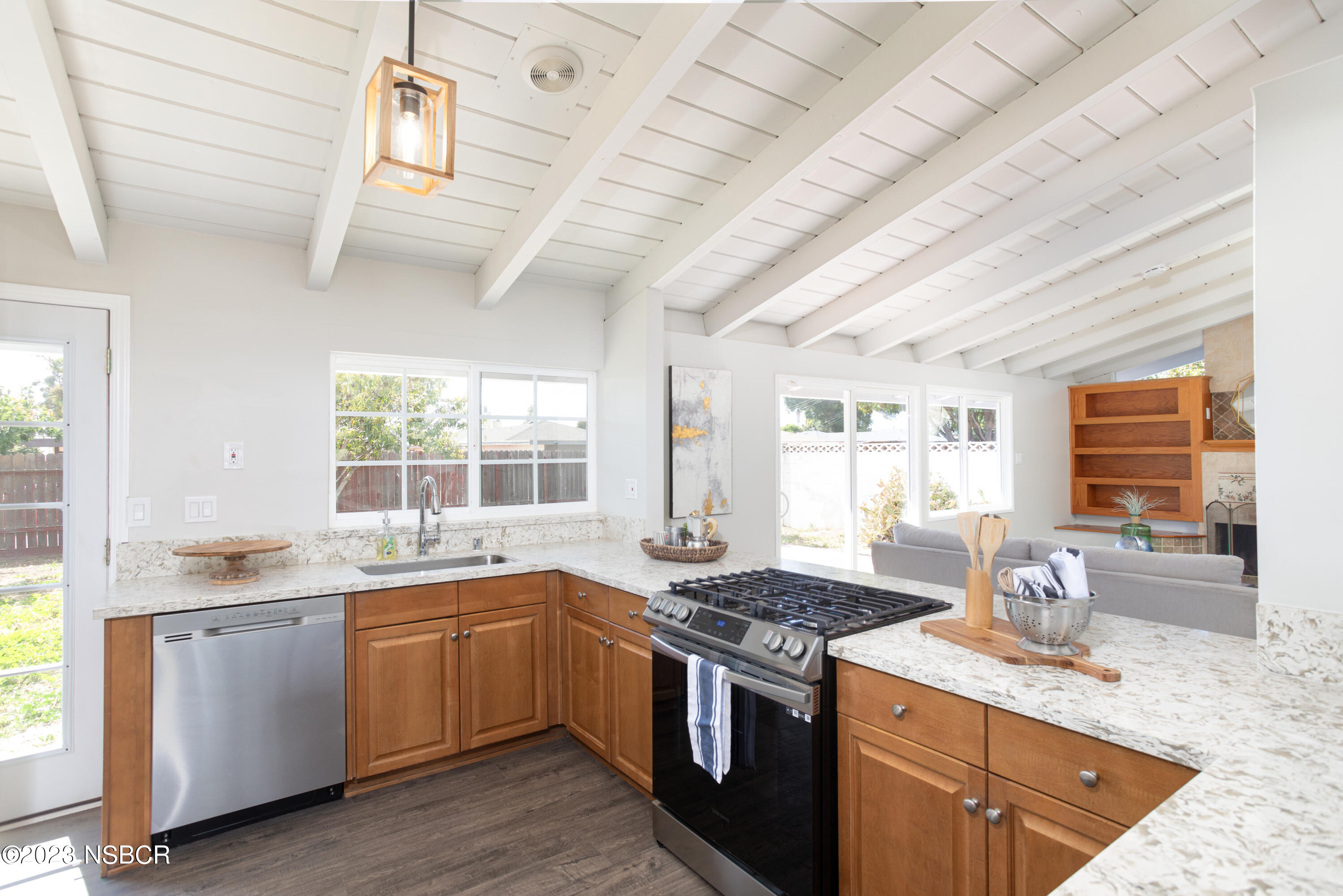 303 North Third Street Lompoc, CA 93436 - Photo 13 of 31 a kitchen with a sink stove and cabinets
