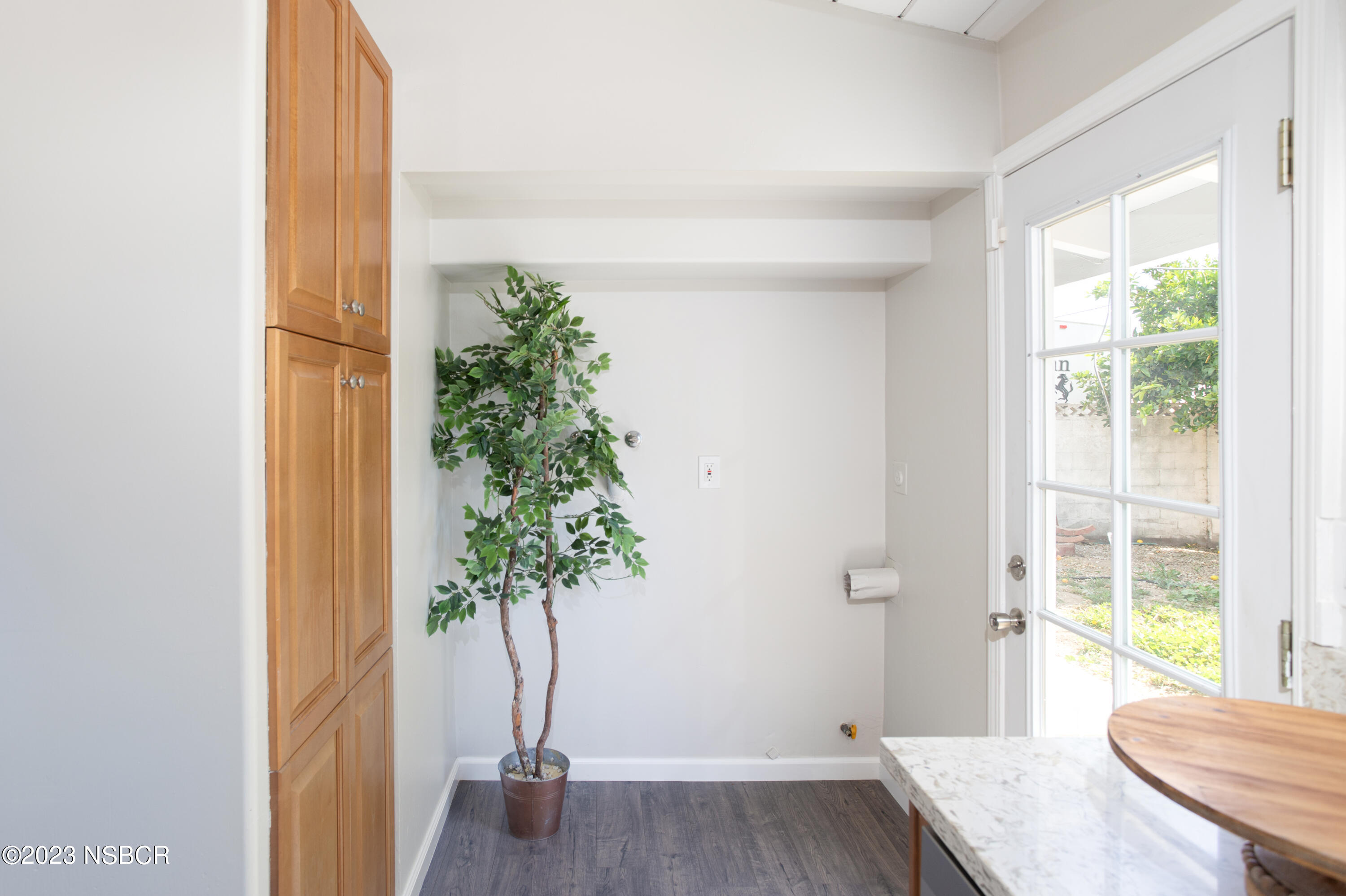 303 North Third Street Lompoc, CA 93436 - Photo 16 of 31 a view of a bedroom with wooden floor and a potted plant