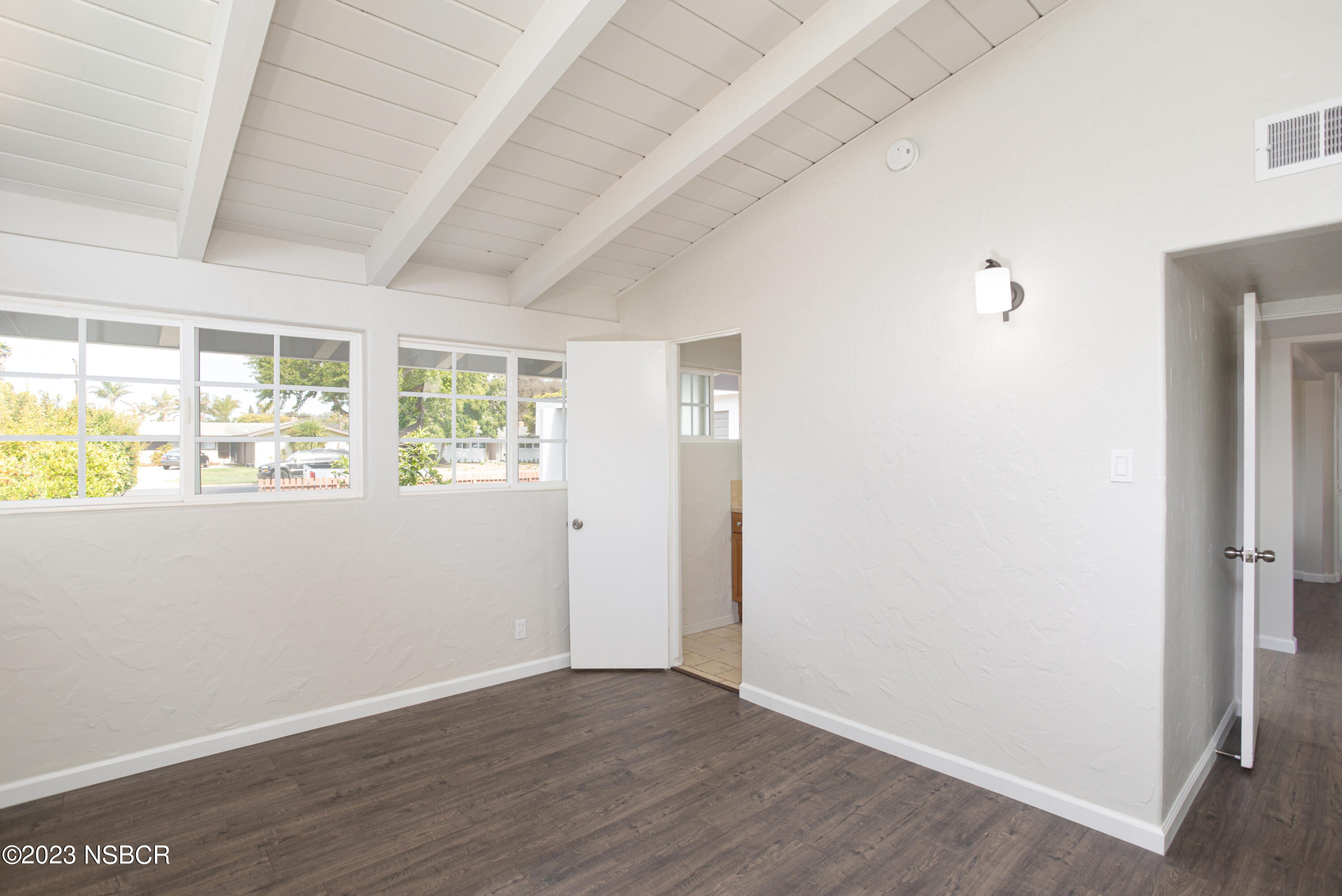 303 North Third Street Lompoc, CA 93436 - Photo 20 of 31 an empty room with wooden floor and windows