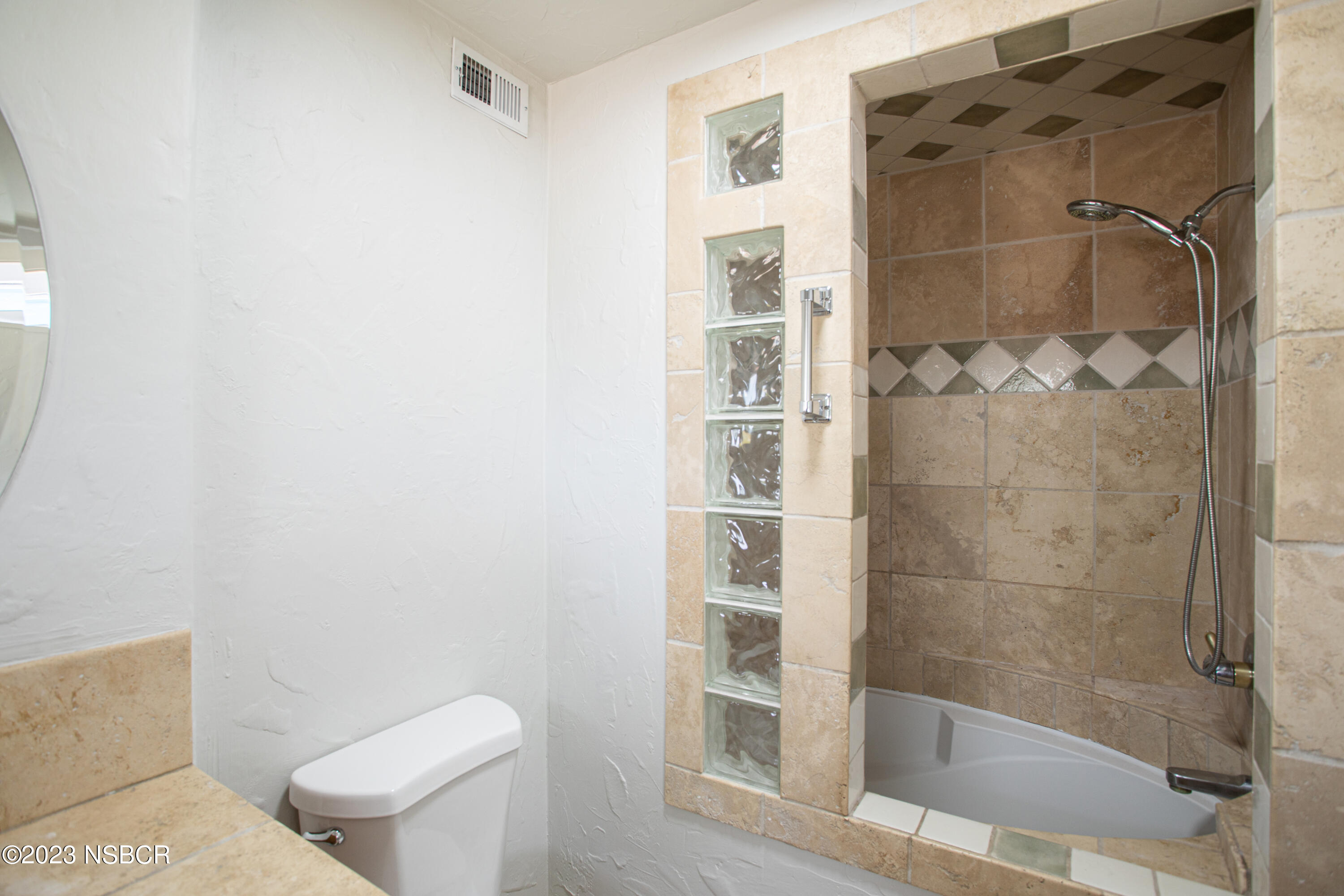 303 North Third Street Lompoc, CA 93436 - Photo 23 of 31 a bathroom with a shower and toilet