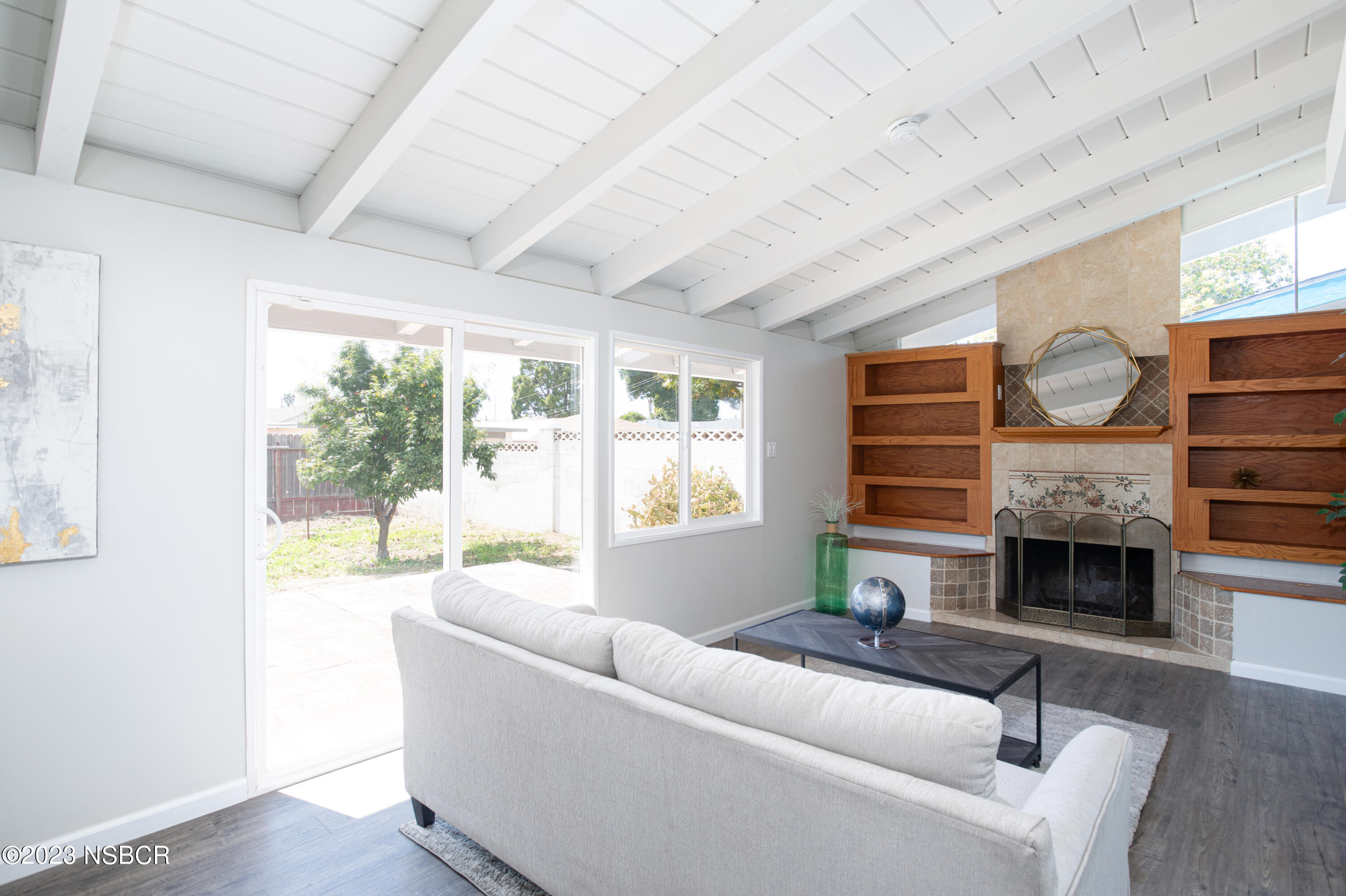 303 North Third Street Lompoc, CA 93436 - Photo 3 of 31 a living room with furniture and a fireplace