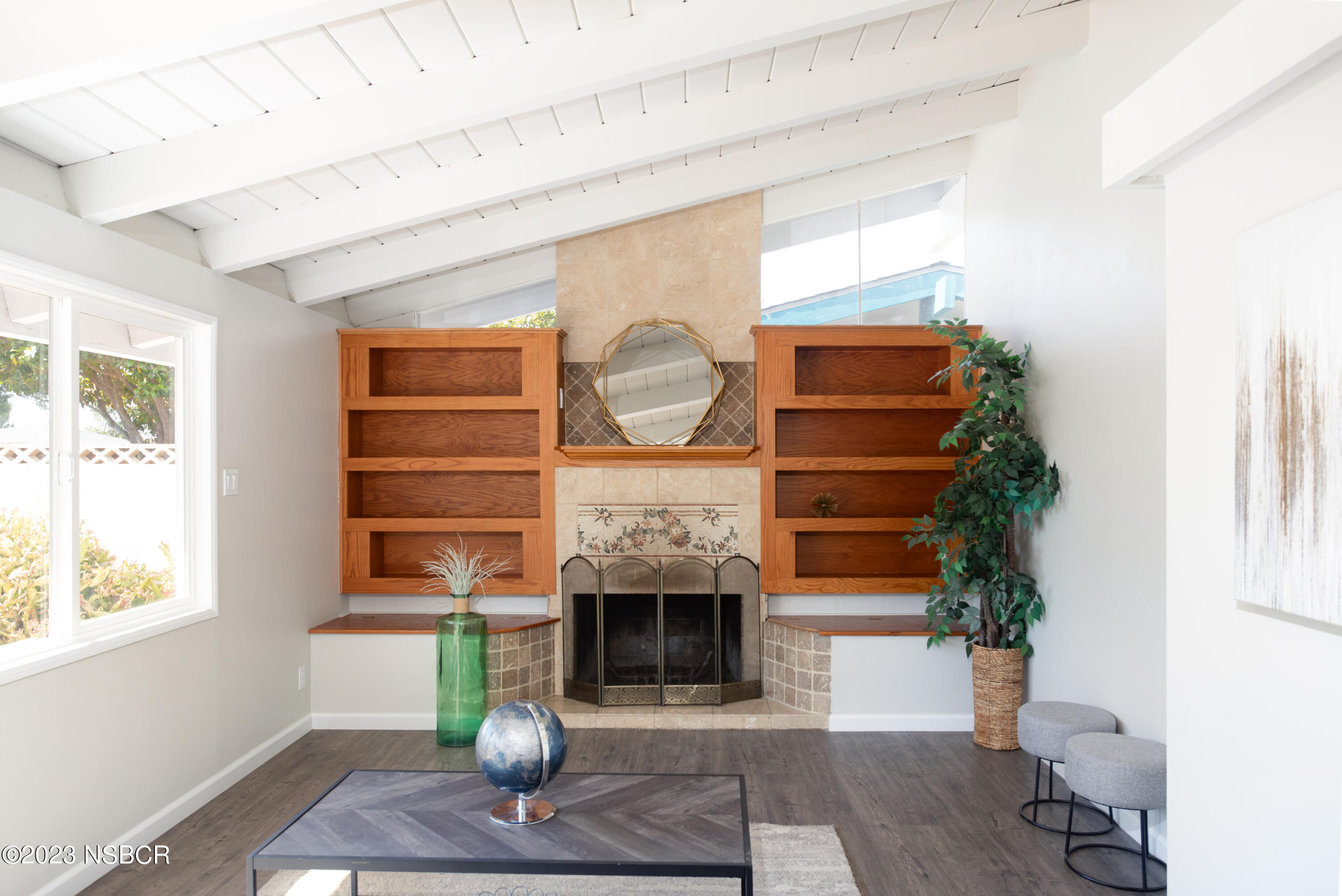 303 North Third Street Lompoc, CA 93436 - Photo 4 of 31 a living room with furniture a window and a fireplace